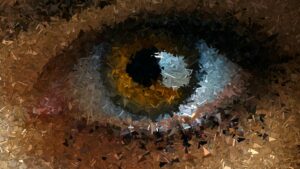 A close-up abstract depiction of an eye using a mosaic of triangular shapes in warm colors.
