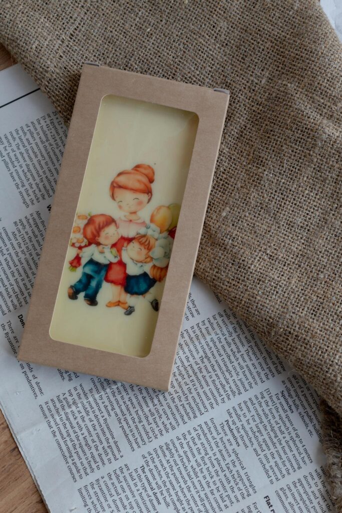 An illustrated card in natural packaging on burlap and newspaper background, artistic and cozy.