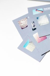 High angle view of abstract design business cards with cutouts on a white background.